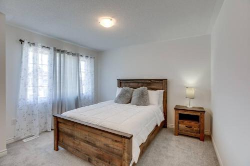 a bedroom with a large bed with a wooden headboard at Beautiful oasis in Midhurst