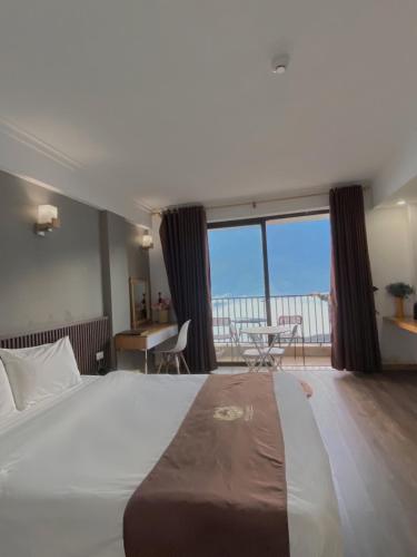 a bedroom with a large bed with a view of the ocean at Roxana Sapa Hotel - by Bay Luxury in Sapa