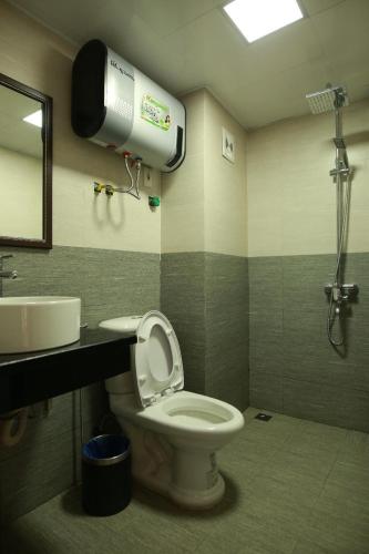a bathroom with a toilet and a sink and a shower at Roxana Sapa Hotel - by Bay Luxury in Sapa