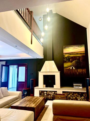 a living room with a couch and a fireplace at Bikeaway Guesthouse in Kereki