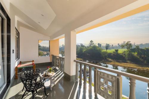 a balcony with a view of a river at JHADOL BAGH - A Riverside Retreat in Jharol