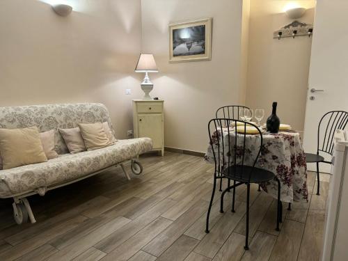 a living room with a couch and a table and chairs at Casa Mia Vaticano Guest House in Rome