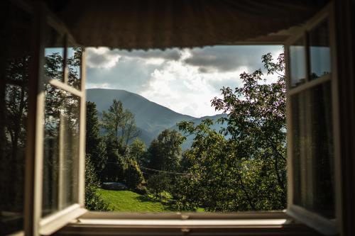 a view of a mountain through a window at Chaloupka na stráni in Ostravice