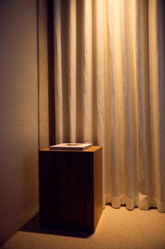 a wooden podium in front of a curtain at Hotel Vyn in Simrishamn