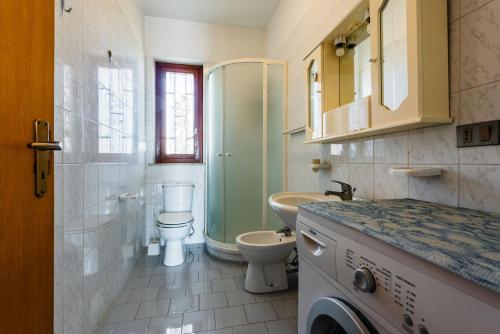 a bathroom with a toilet and a sink and a shower at Capomulini House by Wonderful Italy in Acireale
