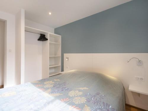 a bedroom with a bed in a white room at Residence Louis Quartier Casino in Vittel