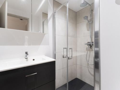 a bathroom with a sink and a shower at Residence Louis Quartier Casino in Vittel