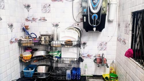 a kitchen with dishes in baskets on the wall at Rooftop Floor with a big Room in New Delhi