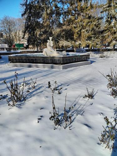 a statue in a park covered in snow at готель Моряк in Chornomorsk