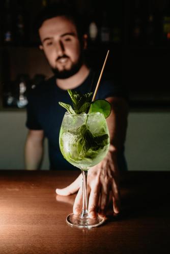 a man sitting at a table with a drink at Amantis Vital Sport Hotel in Desná