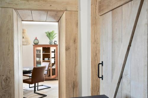 a wooden door in a room with a desk at Vakantiehuis Lott Duravel in Duravel