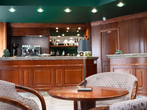 a kitchen with a table and chairs and a bar at Hotel SAN PIO in San Giovanni Rotondo