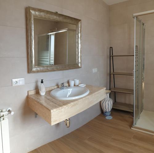 a bathroom with a sink and a mirror at La Casa del Pueblo en Ossa de Montiel in Ossa de Montiel