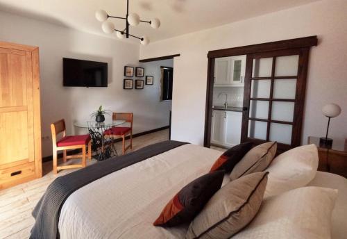 a bedroom with a large bed with pillows on it at MoonLava: Apto, Piscina, WiFi in Yaiza