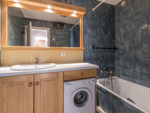 a bathroom with a sink and a washing machine at Appartement La Clusaz, 2 pièces, 4 personnes - FR-1-304-14 in La Clusaz