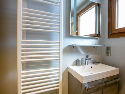 a bathroom with a sink and a mirror at Appartement La Clusaz, 3 pièces, 6 personnes - FR-1-304-271 in La Clusaz