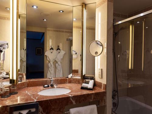 a bathroom with a sink and a shower at Sofitel Lyon Bellecour in Lyon