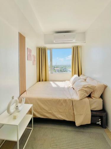 a bedroom with a large bed with a window at * *K2 Nordic Haven in Iloilo City