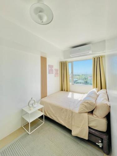a bedroom with a large bed and a window at * *K2 Nordic Haven in Iloilo City