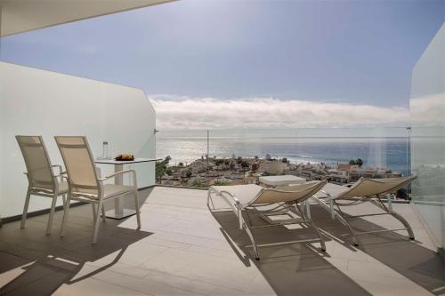 a balcony with chairs and a view of the ocean at Royal Hideaway Corales Beach - Adults Only in Adeje