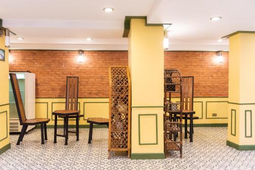 a group of chairs and tables in a room at 75 Paradise Lane Managed by Loft Group in Bangkok