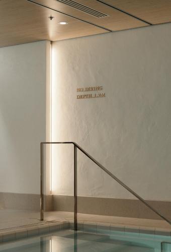 a wall with a sign that says no entrance deficit law at Hotel St. George Helsinki in Helsinki