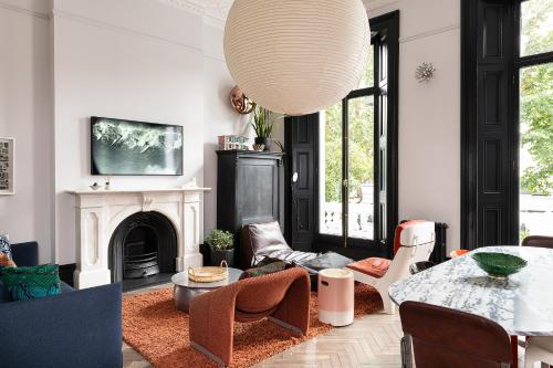 a living room with a table and a fireplace at The Bengal Tiger in Notting Hill in London