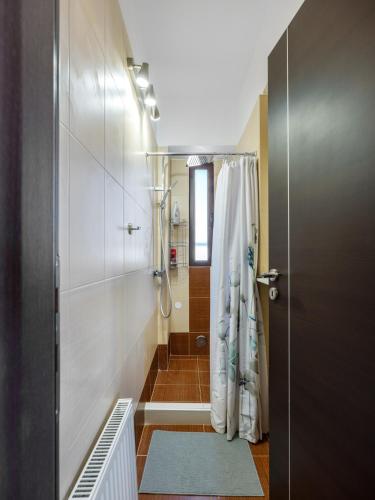 a bathroom with a shower and a shower curtain at Galina's Greek House in Artemida