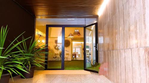 アリカンテにあるCOLLECTION PORT - B&B Boutique , Alicante Centerの廊下の植物の入った部屋への開口ドア