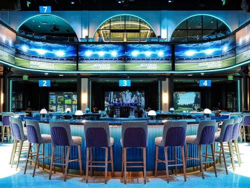 a bar with blue stools in front of a bar at Caribe Royale Orlando in Orlando
