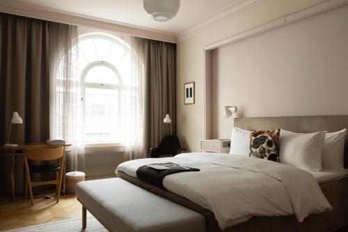 a bedroom with a large bed and a window at Hotel St. George Helsinki in Helsinki