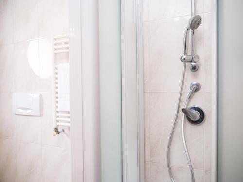 a shower with a shower head in a bathroom at Hotel SAN PIO in San Giovanni Rotondo