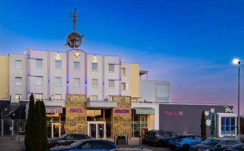 a large white building with a clock on top of it at Best Western Hotel Bad Rappenau in Bad Rappenau