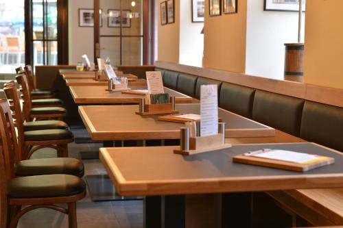 a row of tables and chairs in a restaurant at Hotel Esprit in Prague