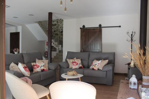 a living room with a couch and tables and chairs at Casa Paula in Segurilla