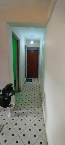 a hallway with a door and a potted plant at Macha AIRBNB in Machakos