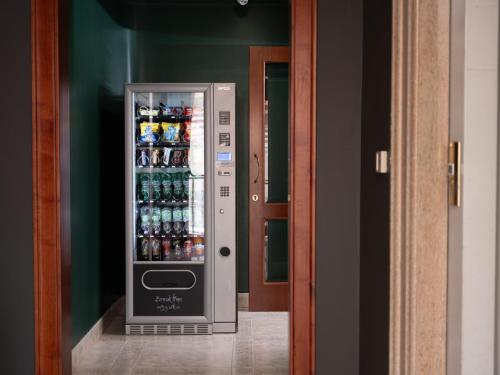 a refrigerator filled with lots of bottles of soda at Hotel SAN PIO in San Giovanni Rotondo