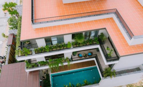 an overhead view of a building with a swimming pool at Peaceful Retreat Seafront Villa Da Nang in Danang