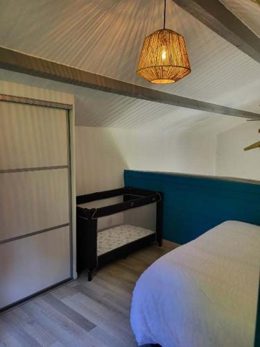 - une chambre avec un lit, une lampe et une porte dans l'établissement Chez Nirina proche Puys DuFou, à Mortagne-sur-Sèvre