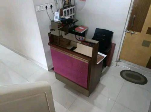 a room with a desk in a room at Hotel Popillon, Kolhapur in Kolhapur