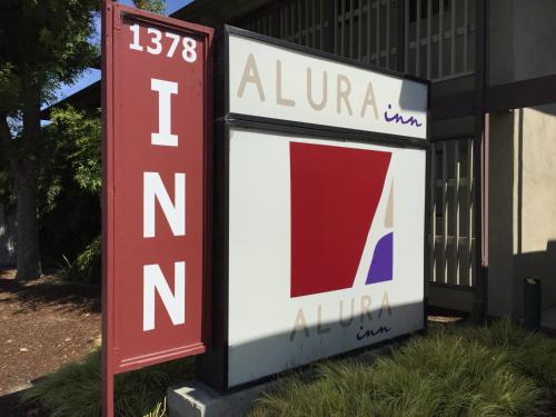 a sign on a building at Alura Inn in San Jose