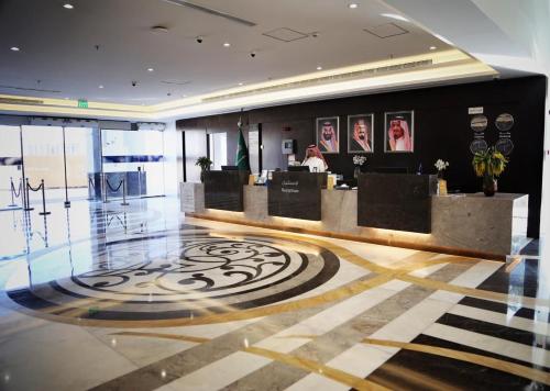 a lobby with a reception desk in a building at Zaha Taiba Hotel in Al Madinah