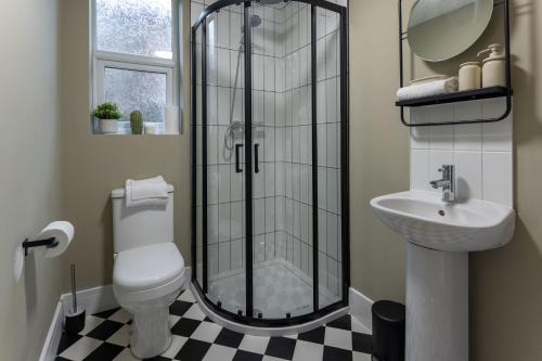 a bathroom with a shower and a toilet and a sink at Broughton Place: Contemporary Apartments in Liverpool in Liverpool