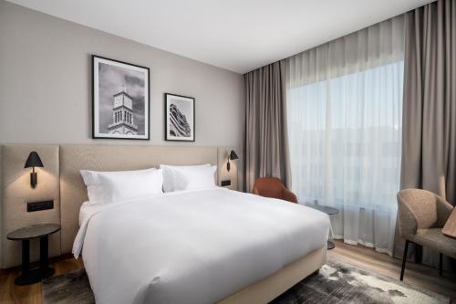 a hotel room with a large bed and a window at Radisson Hotel Casablanca Gauthier La Citadelle in Casablanca