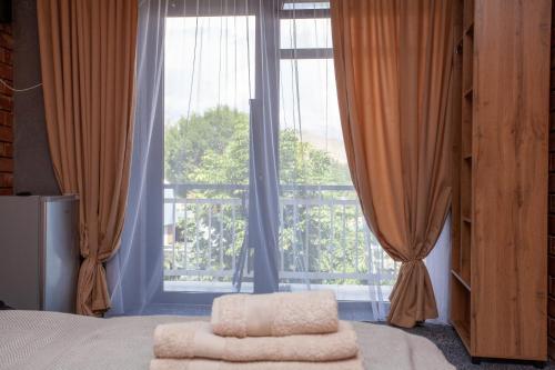 a bedroom with a bed and a large window at Golden street in Cholpon-Ata