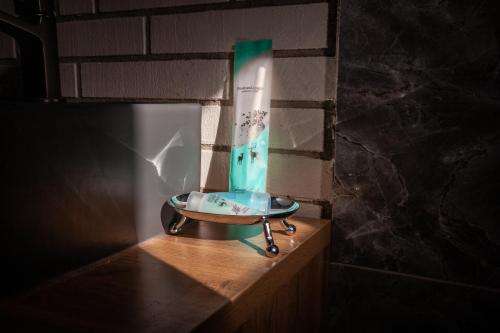a glass sink sitting on top of a wooden counter at Golden street in Cholpon-Ata