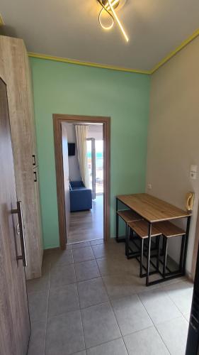 a dining room with a table and a blue couch at ΛΙΜΑΝΙ in Chios