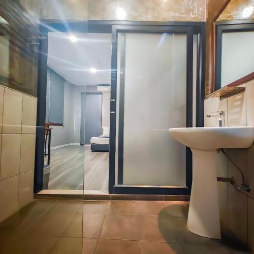 a bathroom with a sink and a mirror at The Riva Vientiane Hotel in Vientiane