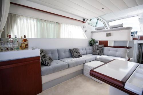 a living room with a couch and a table at Luxury Living on a Yacht in Mikonos