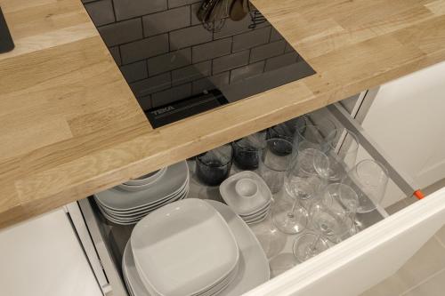 a drawer with plates and glasses in a kitchen at Apartamento WELCS EMP-109- al lado del canal in Empuriabrava